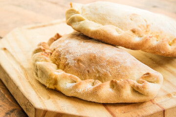 Traditional argentinian empanadas on wooden table