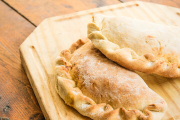 Traditional argentinian empanadas on wooden table