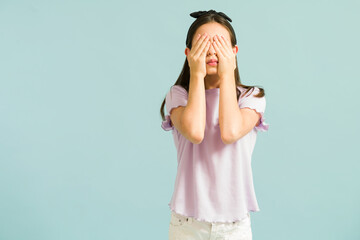 Beautiful little girl playing hide and seek