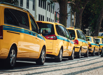 Closeup of yellow taxis parked in the street during daylight