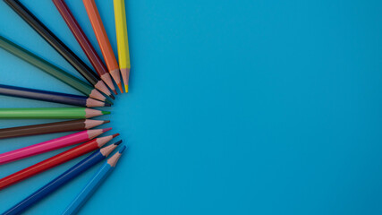 Colored pencils on a blue background. Great For Your Back To School. Art Supplies Related Projects.