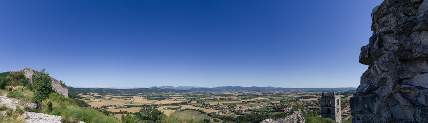 Fototapeta na wymiar Panorama of landscape in Provence with old ruin walls under a clear blue sky near Marsanne, France