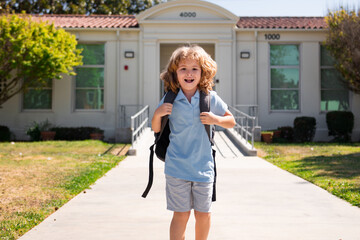 Child pupul with rucksacks in the park near school. Schoolboy with backpacks outdoors. Knowledge day. School uniform.