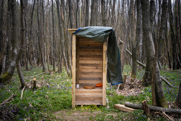 Wooden outhouse toilet in the woods in Kent, England.
