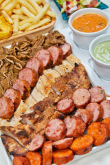 variety of grilled meats and chicken with mayonnaise and sauces