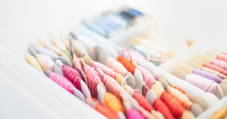 Set of multi-colored cotton threads in the plastic box prepare for handmade embroidering cotton art.