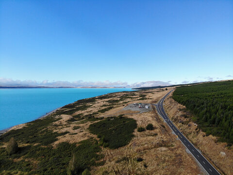 Aerial View Of A Coastal Road And Landscape On The Island Of New Zealand Under A Blue Sky