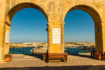 Arch with ancient city in the background and the Mediterranean sea
