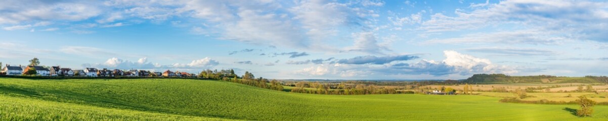 Fototapeta na wymiar Green field panorama in spring season. Landscape of England near Harlington village