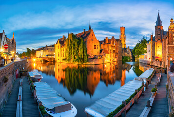 Brugge city centre, often referred to as The Venice of the North, with famous Rozenhoedkaai illuminated in beautiful twilight, West Flanders province, Belgium