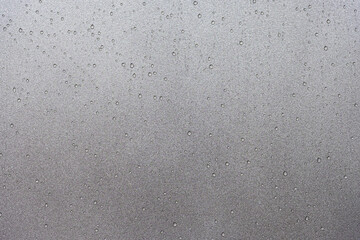 Water droplets on non-stick Surface of Baking Tray, Metallic Paint Texture Background.