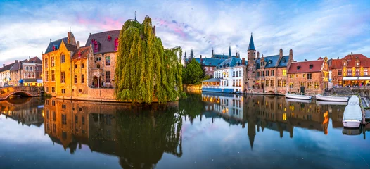 Selbstklebende Fototapeten Sunset panorama Brugge city centre, often referred to as The Venice of the North, with famous Rozenhoedkaai illuminated in beautiful twilight, West Flanders province, Belgium © Pawel Pajor