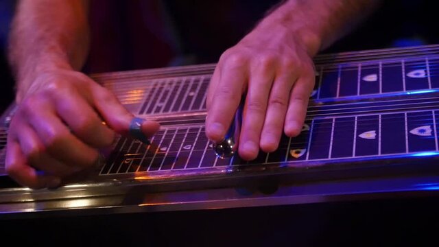 A Shallow Focus Of A Male Musician Playing A Pedal Steel Guitar In HD