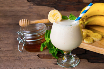 Banana fresh cocktail vanilla smoothies  fruit juice beverage healthy the taste yummy in glass drink episode good morning on wooden background.