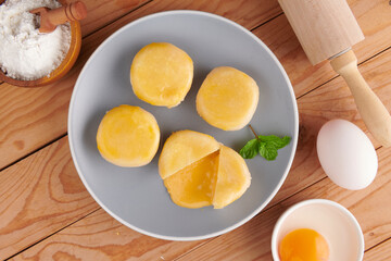 Chinese Dessert Traditional, Sweet Dessert Chinese Style, Asian Dessert. Plate of delicious homemade Chinese pastry with stuffed salted egg yolk lava, selective focus.