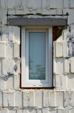Unprofessionally installed window in the facade of a house with construction defects