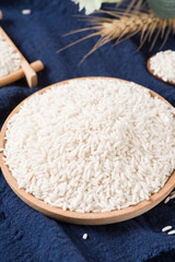 Fototapeta na wymiar Raw organic white rice on wooden background, glutinous rice or sticky rice close up