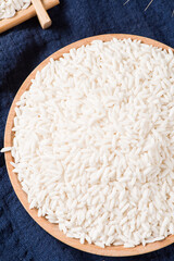 Raw organic white rice on wooden background, glutinous rice or sticky rice close up