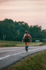 A woman jogging and training on the street and in nature