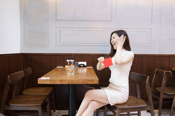 Beautiful young asian woman in traditional white dress named cheongsam sitting in Japanese...
