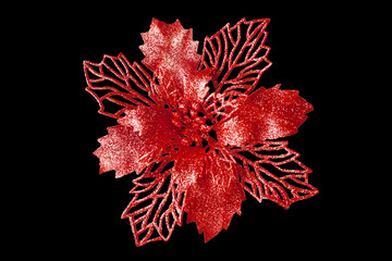 Red flower dark black background isolated close up, beautiful red metal flower, shiny metallic leaves, red floral pattern, Christmas tree decoration, New Year decor, vintage decorative design element