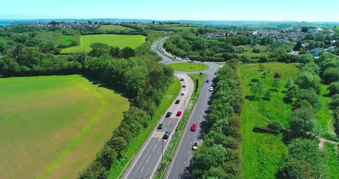 Drone flies away from hellevoetsluis way revealing small devon town in Marldon