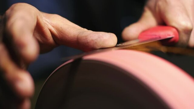 knife sharpening. close up. 4K.
Work on a sharpening machine.