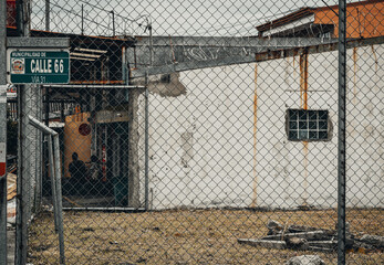 Old housbehind a barbed wire fence