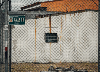 Old building behind a barbed wire fence