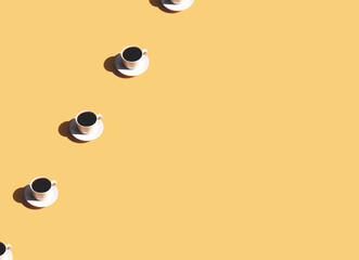 Pattern of coffee cup and plate, shadow of sun on beige terracotta background