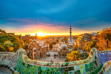 Obraz premium Beautiful sunrise in Barcelona seen from Park Guell. Park was built from 1900 to 1914 and was officially opened as a public park in 1926. In 1984, UNESCO declared the park a World Heritage Site