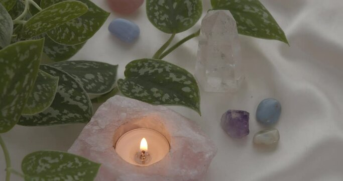 Rose Quartz candle with healing crystals and plants