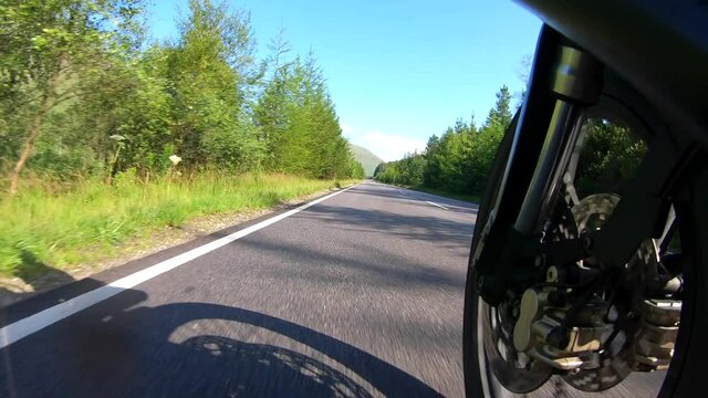 Motorcycle tour in Glencoe Scotland highlands hills and trees