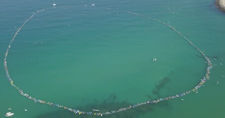 A circle of surfers in Mediterranean Sea Aerial view
World record of Nearly 1,000 surfers took part in a protest against natural gas production near Israel‚Äôs coastline, 2018