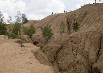 Turquoise water lakes and the mud erosion of the soil looks like mountains. Beautiful natural landscape. Konduki, Tula region, Romancevskie mountains, Abandoned Ushakov quarries.