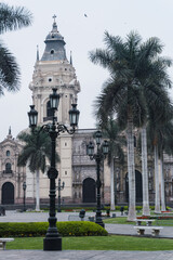 Fototapeta na wymiar Lima main square empty during pandemic times, view of Lima cathedral , Archbishop’s Palace, palms in main square