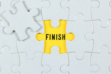 Fototapeta premium Finish Text on Puzzle Piece - business concept