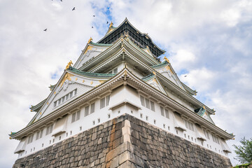 Fototapeta na wymiar Osaka castle against the sky. Symol of the city and Japan located in the Osaka park has been built in 1597