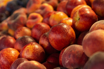 Juicy ripe peaches on the market counter. Healthy food and vitamins. Close-up.
