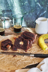 Chocolate banana bread. Side view. wooden background. Coffee.
