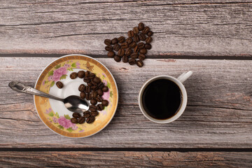 dark coffee and grains on wooden background