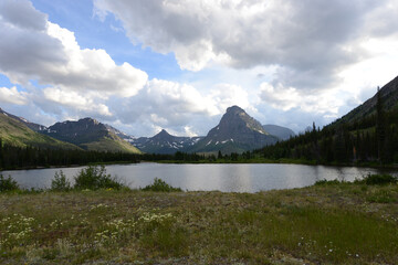 Scenic view of mountains, trees and a lake at Glacier National Park in Montana