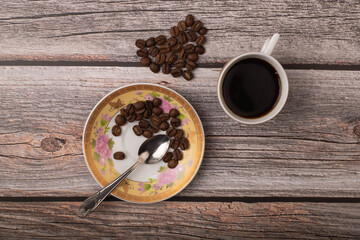 dark coffee and grains on wooden background