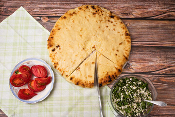 Ossetian pie, cottage cheese with herbs closeup national food