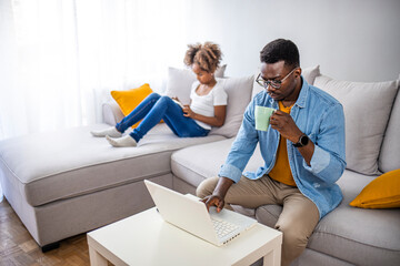 Multi-tasking, freelance and fatherhood concept - working father with daughter and laptop computer at home office. Father working at home. Multitasking father working from home