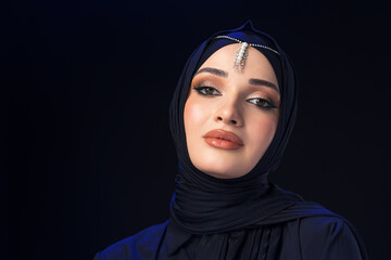 Naklejka premium Close up portrait of beautiful muslim girl dressed in hijab