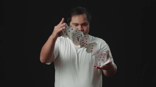 Asian Magician Does Card Trick Throwing Deck From One Hand To Another. Slow Motion

