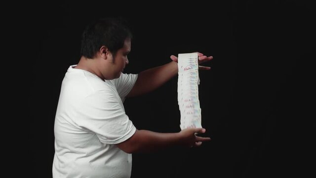 Asian Magician Starts Showing His Trick With Cards, Cards Cascading Down. Slow Motion
