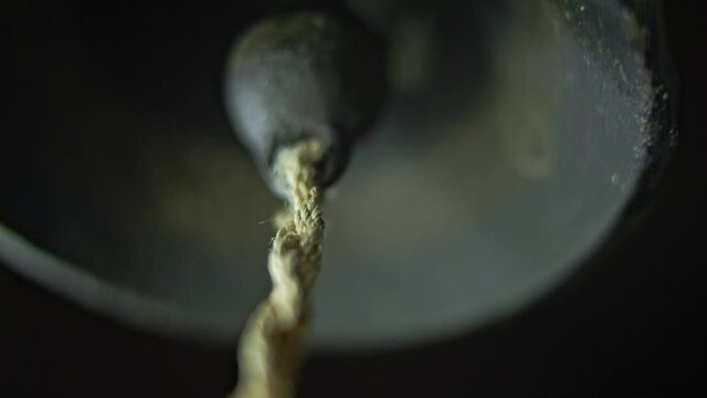 The bell of a small metal bell. The old bell rings.