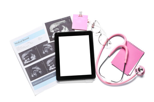 Tablet computer with stethoscope and ultrasound image of baby on white background